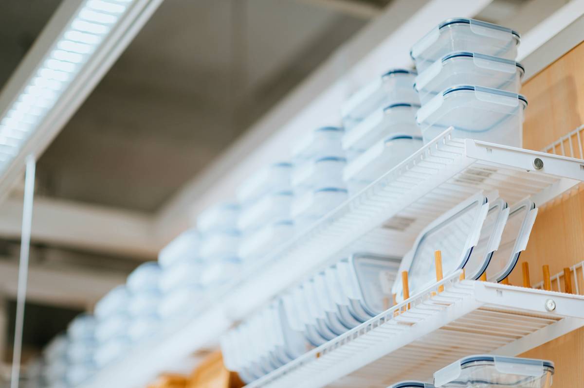 Silicone containers for refrigerated food stacked neatly in a refrigerator drawer with visible condensation-free seals and vibrant food inside