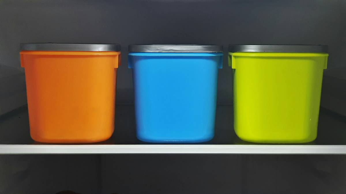Silicone food storage box holding chopped vegetables with lid sealed tightly